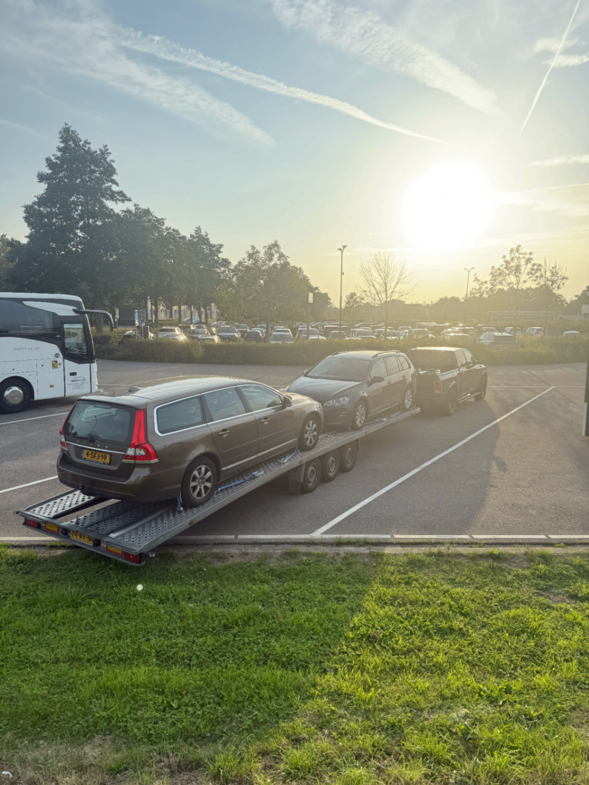 Autotransporter met drie personenauto's tijdens een landelijke rit